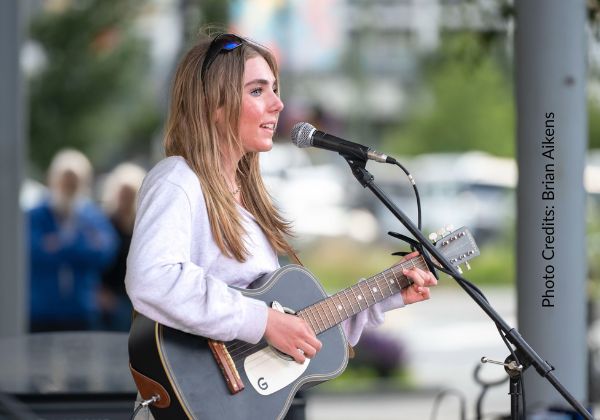 A student performing at a guitar studio recital in Squamish