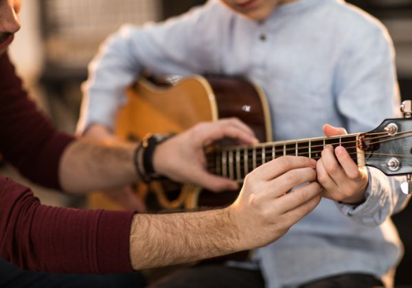 Guitar teacher working with a student during a private lesson in Squamish